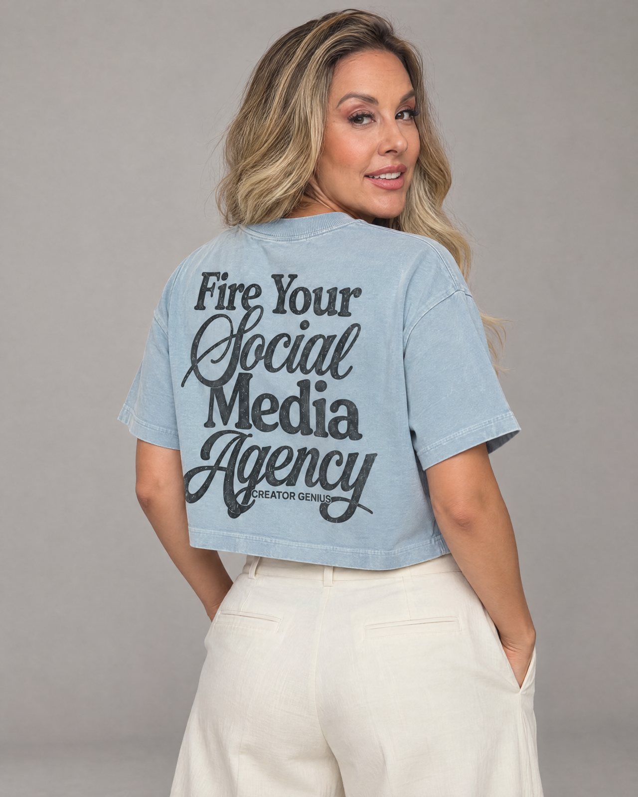 Model wearing the denim crop, back view, in a studio, lifestyle view